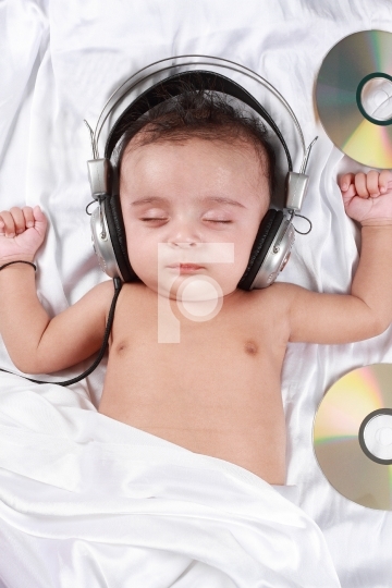 2 Month old baby listening to music with headphones