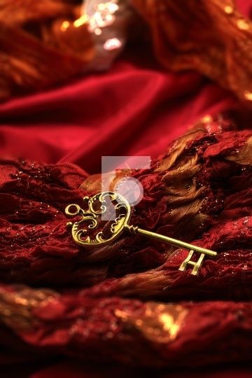 Antique Golden Key on Red Fabric Background