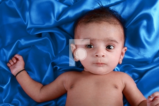 Baby boy with blue satin background