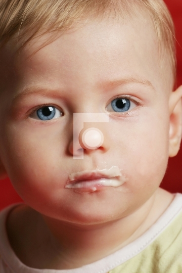 baby eating food on the face