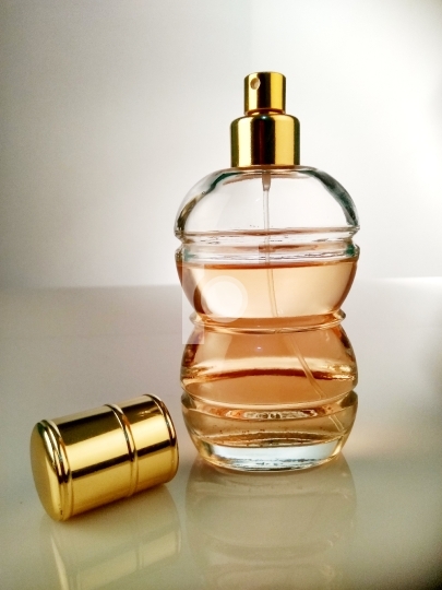 Beautiful Perfume Bottle On White Reflective Surface Free Stock 
