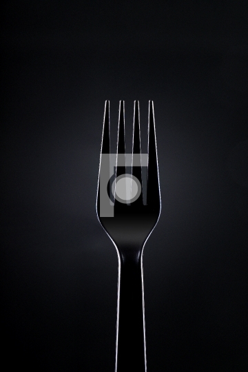 Black Plastic Fork on Dark Background 
