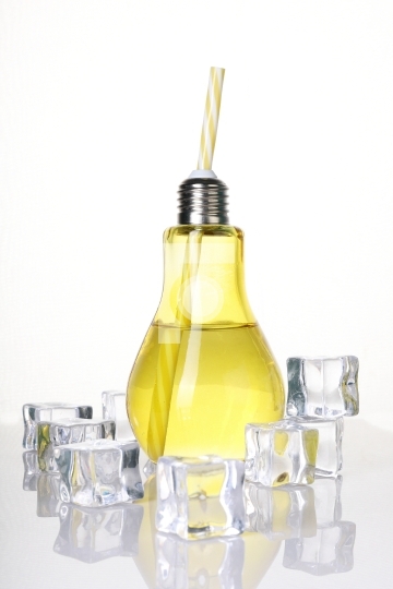 Bulb Shaped drinking glass in Yellow with Ice Cubes on White Bac