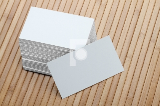 Bunch of Blank White Business Card on Wooden Background