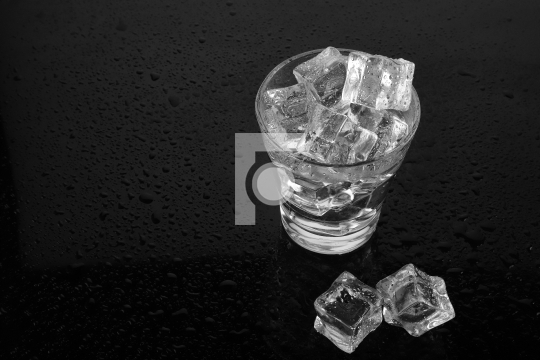 Chilled Glass of Water Filled with Ice on black water_drop_s backg