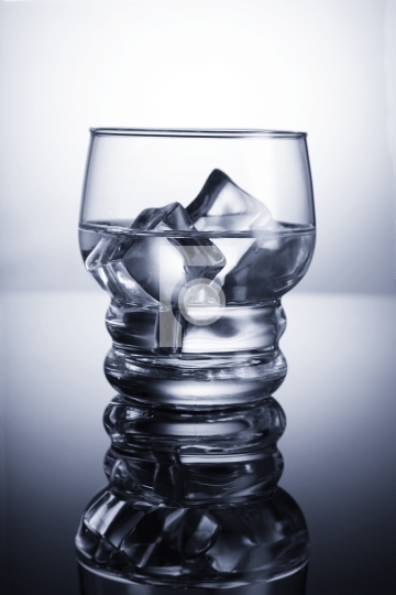 Chilled glass of water with ice cubes