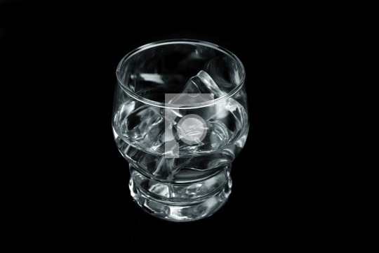 Chilled Water with Ice Cubes on Black Background