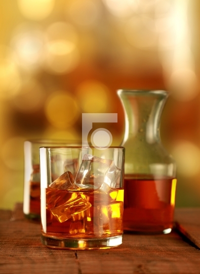 Chilled Whisky Glass with Ice Cubes on Blurred Background