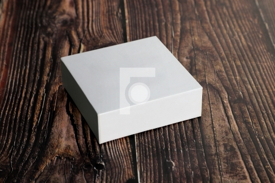 Clean White Blank Product Packaging Box for Mock ups on Wooden B