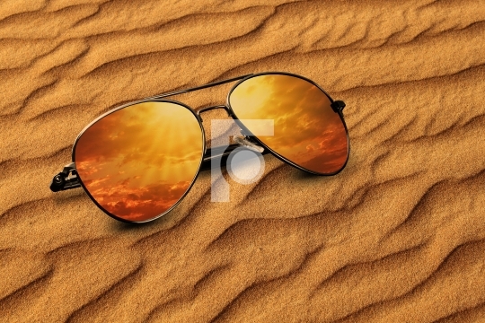 Desert sand and Sunglasses Reflection Vacation Concept