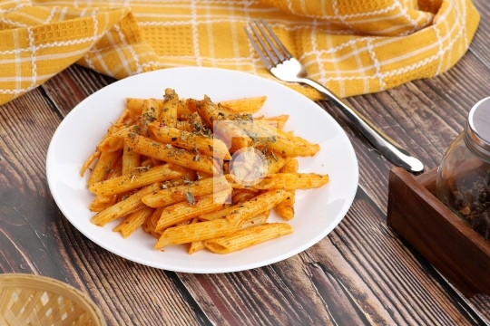 Food - Tasty Penne Pasta Plate with a Fork on Wooden Table