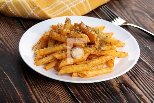 Food - Tasty Penne Pasta Plate with a Fork on Wooden Table