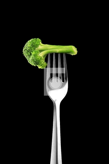 Food Broccoli on a Fork on Black Background