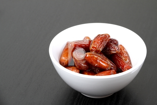Fresh dates in a white bowl