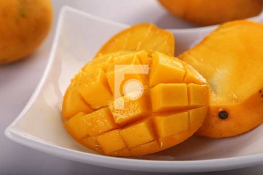 Fresh Organic Mango Fruit Sliced in a White Plate