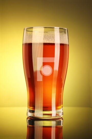 Full Beer Glass with Yellow Background