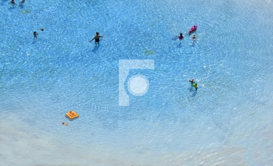 group of people swimming on the beach