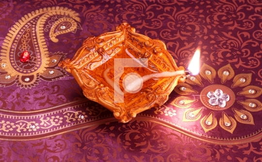 Handmade Diwali Clay Lamp on Floral Background