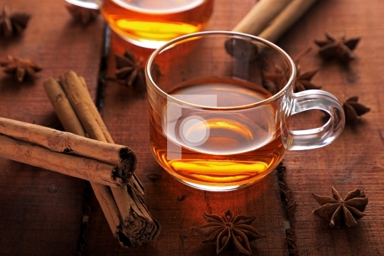 Healthy Herbal Tea with Star Anise and Cinnamon in a Cup on Wood
