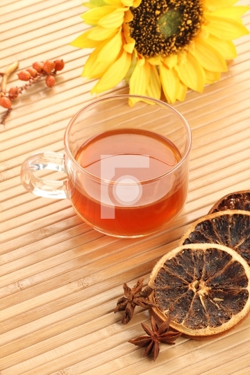 Herbal Tea Cup with Dried Lemon on Wooden Background