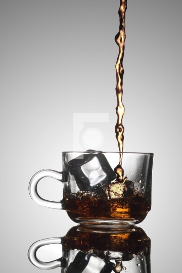 Ice Tea Poured into a Glass Tea Cup