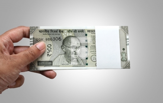 Indian Currency Rupee 500 Bank Note Bundle in a Hand