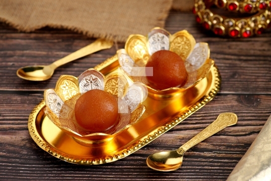 Indian Dessert Sweet Food Gulab Jamun in a traditional metal bow