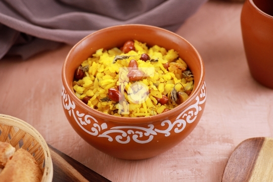 Indian Food Maharashtra Poha with Peanuts in a Pottery Bowl