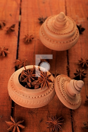 Indian Spice Star Anise in a Handmade Pottery Container
