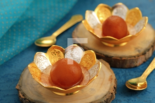 Indian Sweet Food Gulab Jamun in a traditional metal bowl
