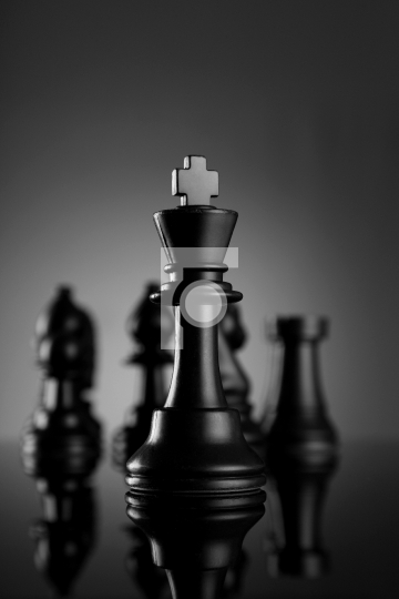 Leadership Chess King with pieces on dark background