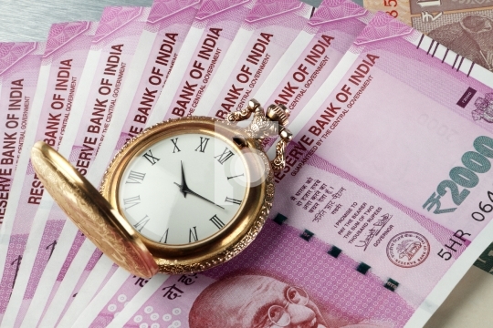 New Indian Rupees Currency with antique time watch