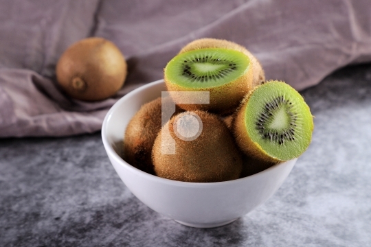 Organic Healthy Kiwi Fruit in a White Bowl
