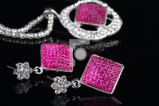 Pink Colored Jewelry Set with Earrings in focus