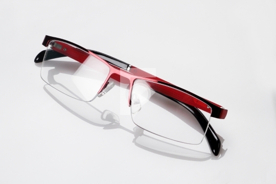 Red Black Eyeglasses with Reflection on White Background
