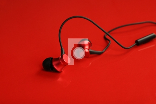 Red Colored Wired EarPhone on Red Background