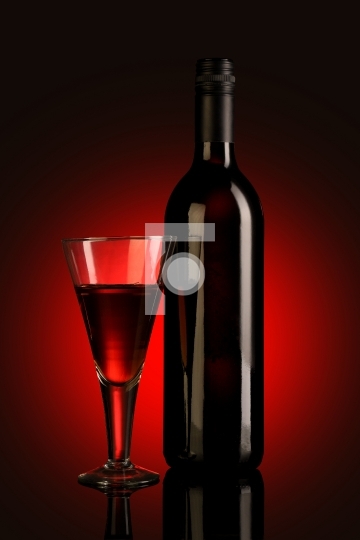 Red Wine Glass and Bottle on Red Background