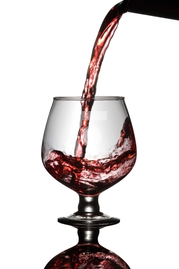 Red Wine Poured into a glass from bottle