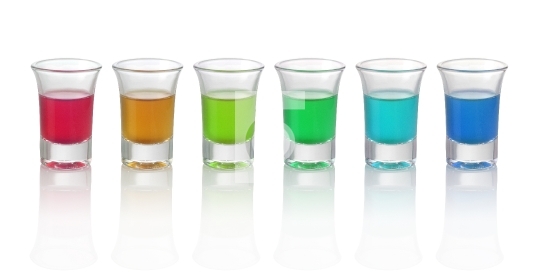 Six different color drinks in glasses on white background