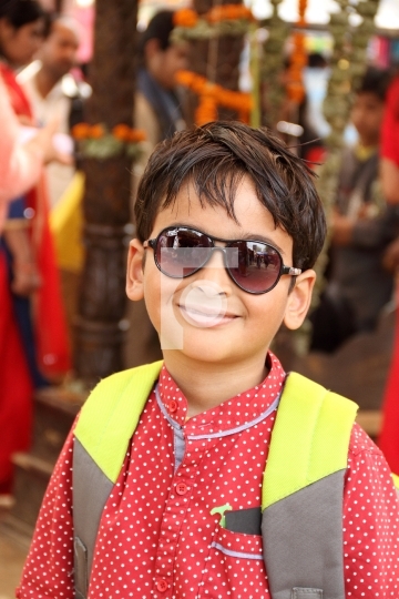 Smiling Indian Boy with a Backpack Outdoors