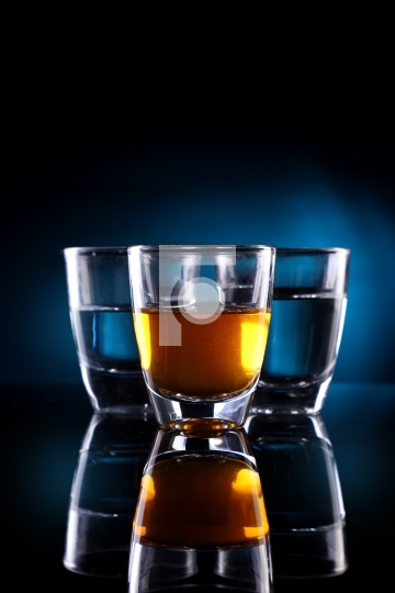 Three Shot glasses with alcohol drinks