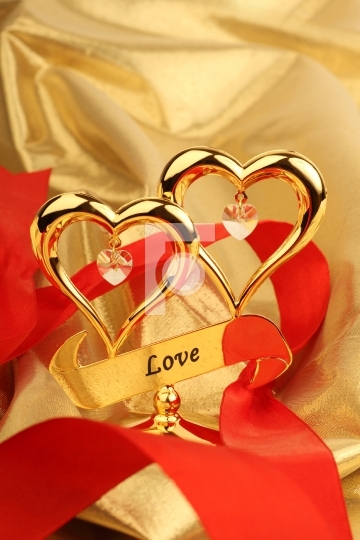 Two Golden heart on a gold color fabric