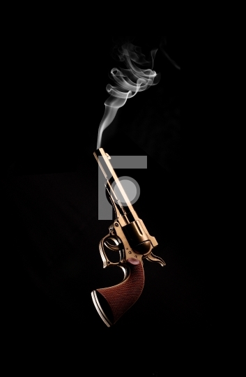Vintage / Antique Gun and Smoke Coming Out on Black Background