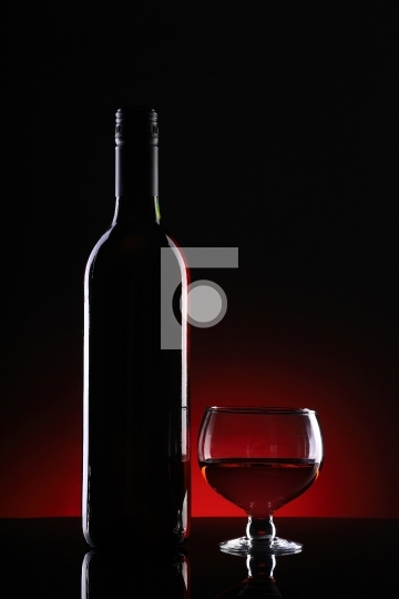Wine Bottle and Glass on Dark Background