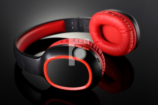 Wireless Bluetooth Headphones Gadget on Black Reflective Backgro
