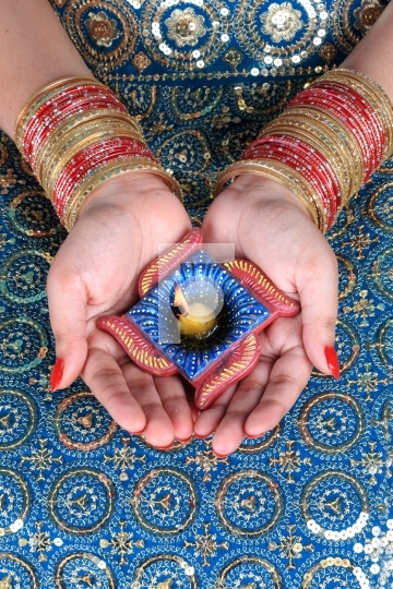 Diwali Celebration Diya on a Female Hand