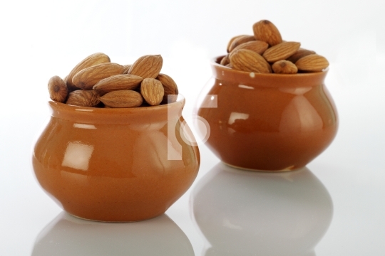 Dry Fruits Almonds in Ceramic Pot on white background